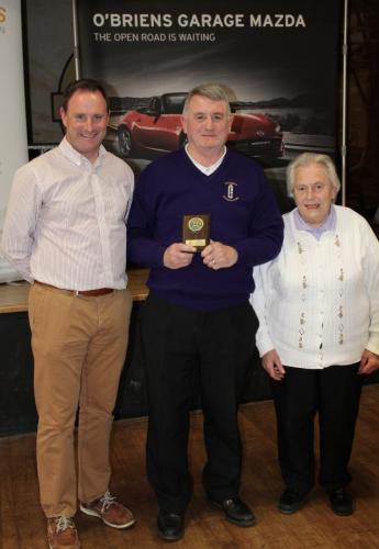 Patrick Casey (Ballynoe) receiving Division 6 runners up Plaque from Roy Corbett, O'Briens Garage