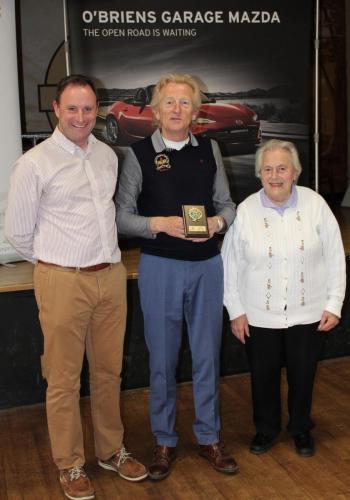 Liam Hickey (Lower Aghada) receiving Division 5 runners up Plaque from Roy Corbett, O'Briens Garage