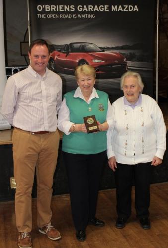 Eileen Kiely (Wilton Yellow) receiving Division 4 runners up Plaque  from Roy Corbett, O'Briens Garage 