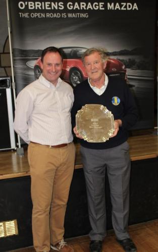 Denis Geary (Carrigtwohill) receiving Division 7 Winners Shield from Roy Corbett, O'Briens Garage