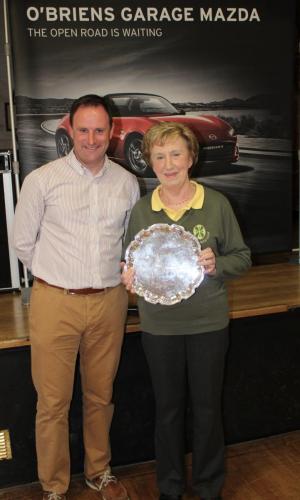 Mary Murphy (Iona Green) receiving Division 6 Winners Shield from Roy Corbett, O'Briens Garage