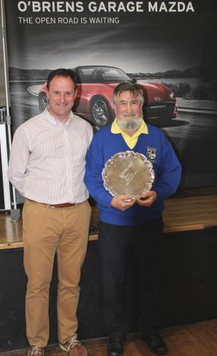 Michael Fitzgerald (Pfizers) receiving Division 4 Winners Shield from Roy Corbett, O'Briens Garage